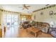 Bright living room with sliding glass doors and hardwood floors at 34239 Woodridge Ln, Eustis, FL 32736