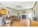 Spacious living room with hardwood floors, fireplace, and natural light at 34239 Woodridge Ln, Eustis, FL 32736