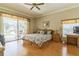 Bright main bedroom features a sliding glass door to the backyard at 34239 Woodridge Ln, Eustis, FL 32736