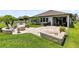 An outdoor patio features a fire pit, stone seating, and a paved area perfect for entertaining at 3630 Trimaran Dr, Orlando, FL 32820