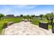 A backyard patio features a fire pit, outdoor kitchen, and a large paved area for entertaining at 3630 Trimaran Dr, Orlando, FL 32820