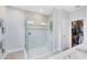Bathroom featuring a glass shower with a bench seat and a view of the walk-in closet at 3630 Trimaran Dr, Orlando, FL 32820