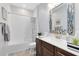 Bathroom with mosaic mirror over the sink, white backsplash and brown vanity at 3630 Trimaran Dr, Orlando, FL 32820