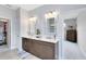 Bathroom featuring double sinks, framed mirrors, and a walk-in closet, exuding modern elegance at 3630 Trimaran Dr, Orlando, FL 32820