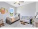 Sunlit bedroom with a crib and a twin bed, showcasing a cozy and inviting space at 3630 Trimaran Dr, Orlando, FL 32820