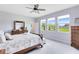 Bedroom with three windows showing a landscaped yard, a ceiling fan, and light grey walls at 3630 Trimaran Dr, Orlando, FL 32820