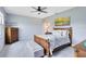 Bedroom with a ceiling fan, plank accent wall, wood furniture, and a cozy aesthetic at 3630 Trimaran Dr, Orlando, FL 32820