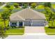 Shot of the exterior of this charming single-story home with 3 car garage, porch, and a professionally landscaped yard at 3630 Trimaran Dr, Orlando, FL 32820