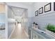 Stylish hallway featuring wainscoting, wood-look tile flooring, decorative lanterns, and an open view to the living spaces at 3630 Trimaran Dr, Orlando, FL 32820