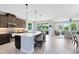 Open kitchen view featuring an island with bar seating and stainless steel appliances flowing to the living room at 3630 Trimaran Dr, Orlando, FL 32820