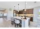Kitchen island with bar seating and pendant lighting, and stainless steel appliances and dark wood cabinets at 3630 Trimaran Dr, Orlando, FL 32820