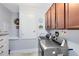 Well-equipped laundry room with modern appliances and cabinetry for organized storage at 3630 Trimaran Dr, Orlando, FL 32820
