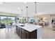 Open-concept living space, island kitchen with seating, dining area, and comfortable living room flowing together at 3630 Trimaran Dr, Orlando, FL 32820