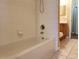 Bathroom featuring a clean bathtub with white tiles and a shower-head at 3658 Oakdale Cir # 100, Oviedo, FL 32765