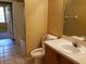 Bathroom featuring toilet and sink with chrome faucet and wood cabinet and view of a bathtub at 3658 Oakdale Cir # 100, Oviedo, FL 32765