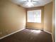 Bedroom featuring neutral paint, large window, ceiling fan, and plush carpet at 3658 Oakdale Cir # 100, Oviedo, FL 32765