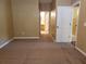 Spacious bedroom with carpet and view into bathroom and closet areas at 3658 Oakdale Cir # 100, Oviedo, FL 32765