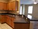 Kitchen features wooden cabinetry, dark countertops, and a stainless steel sink at 3658 Oakdale Cir # 100, Oviedo, FL 32765
