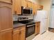 Bright kitchen with stainless steel appliances, including a range, microwave, and refrigerator at 3658 Oakdale Cir # 100, Oviedo, FL 32765
