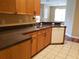Open-concept kitchen with stainless steel sink, tile flooring and view into the living area at 3658 Oakdale Cir # 100, Oviedo, FL 32765