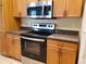 Kitchen featuring stainless steel appliances with ample counter space and wooden cabinetry at 3658 Oakdale Cir # 100, Oviedo, FL 32765