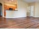 Open-concept living space with wood flooring and bar seating overlooking the kitchen at 3658 Oakdale Cir # 100, Oviedo, FL 32765