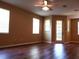 Living room showcasing wood flooring and natural light from windows and sliding glass door at 3658 Oakdale Cir # 100, Oviedo, FL 32765