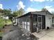 Inviting back porch enclosed with screens and surrounded by lush greenery and potted plants at 40431 Country Rd, Eustis, FL 32736