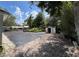 Spacious backyard with large garden area, shed, and mature trees on a sunny day at 40431 Country Rd, Eustis, FL 32736