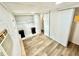 Bedroom featuring wood-look flooring, closet, and two small end tables at 40431 Country Rd, Eustis, FL 32736