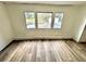 An empty bedroom with wood-look floor and white walls at 40431 Country Rd, Eustis, FL 32736