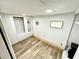 Simple bedroom with white walls and wood-look floor with closet at 40431 Country Rd, Eustis, FL 32736