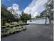Exterior view of a white building with a large paved area for storage, under a partly cloudy sky at 40431 Country Rd, Eustis, FL 32736