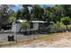 Charming single-story home with a well-maintained yard and a chain-link fence, showcasing a peaceful residential setting at 40431 Country Rd, Eustis, FL 32736