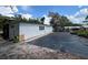 Exterior of the home surrounded by gravel, landscaping fabric, and garden in the background at 40431 Country Rd, Eustis, FL 32736