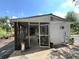 Exterior shot of a single Gathering home with a screened in porch and garden in the backyard at 40431 Country Rd, Eustis, FL 32736