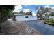 Exterior view of a white building with an adjacent paved area and surrounding landscaping, creating a serene ambiance at 40431 Country Rd, Eustis, FL 32736