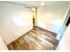 Spacious room with wood-look floors, neutral walls and a doorway to another room at 40431 Country Rd, Eustis, FL 32736