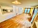 Living room with wood-look floors, a painting, and glass doors to an outside area at 40431 Country Rd, Eustis, FL 32736