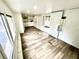Spacious living area with lots of natural light from the windows and a sliding glass door at 40431 Country Rd, Eustis, FL 32736