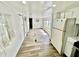Living room with wood-look floors and an adjoining kitchen at 40431 Country Rd, Eustis, FL 32736