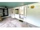 Enclosed porch featuring a concrete floor, ceiling fan, and open view into the home at 40431 Country Rd, Eustis, FL 32736