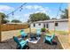View of backyard fire pit and string lights from the exterior featuring a wooden fence at 410 W Seminole Ave, Eustis, FL 32726