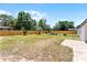 View of the expansive backyard with wooden fence and an inviting patio seating area at 410 W Seminole Ave, Eustis, FL 32726