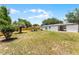 Spacious backyard with a wooden fence and outdoor seating area, perfect for entertaining or relaxing at 410 W Seminole Ave, Eustis, FL 32726