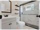 Stylish bathroom featuring a modern vanity and a shower with black fixtures and beautiful marble-patterned tiling at 410 W Seminole Ave, Eustis, FL 32726