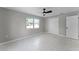 Neutral bedroom with natural light, tile floors, and a spacious closet for ample storage at 410 W Seminole Ave, Eustis, FL 32726