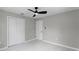 Clean bedroom with a ceiling fan, tile floors, and double door closet with neutral paint at 410 W Seminole Ave, Eustis, FL 32726