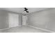 Neutral bedroom with modern lighting, tile floors, and a closet with modern doors at 410 W Seminole Ave, Eustis, FL 32726