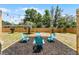 Outdoor seating featuring a fire pit, Adirondack chairs, and overhead string lights in the spacious backyard at 410 W Seminole Ave, Eustis, FL 32726